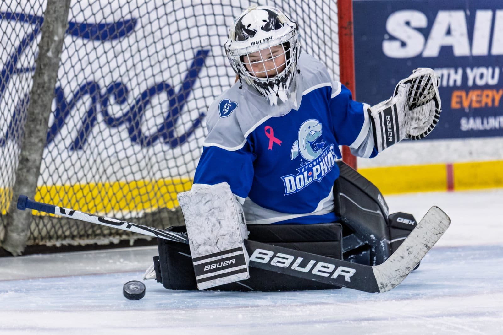 Blocker save at the post, the puck frozen against the goaltender's pad